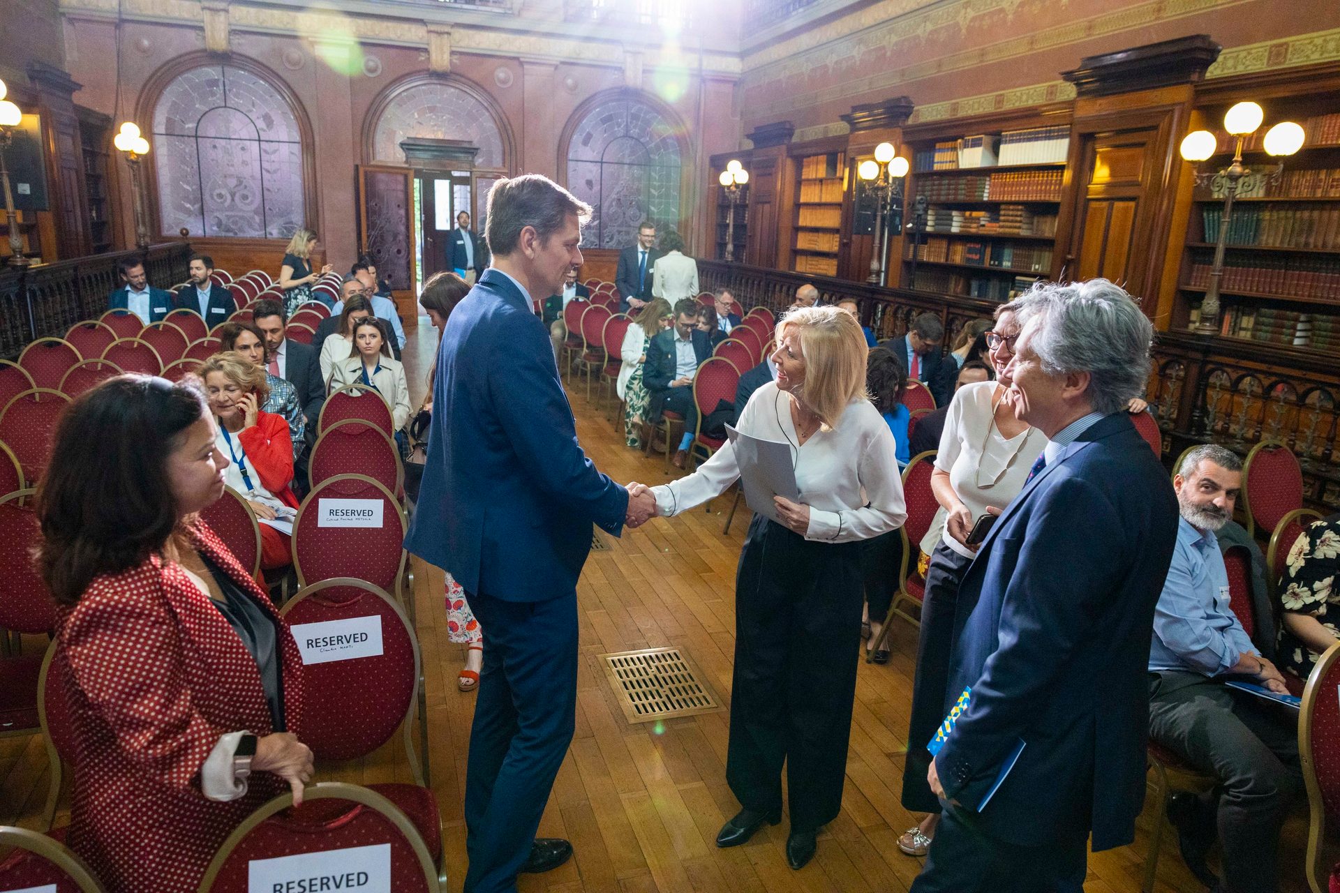 Social group, Trousers, Outerwear, Shelf, Chair, Crowd